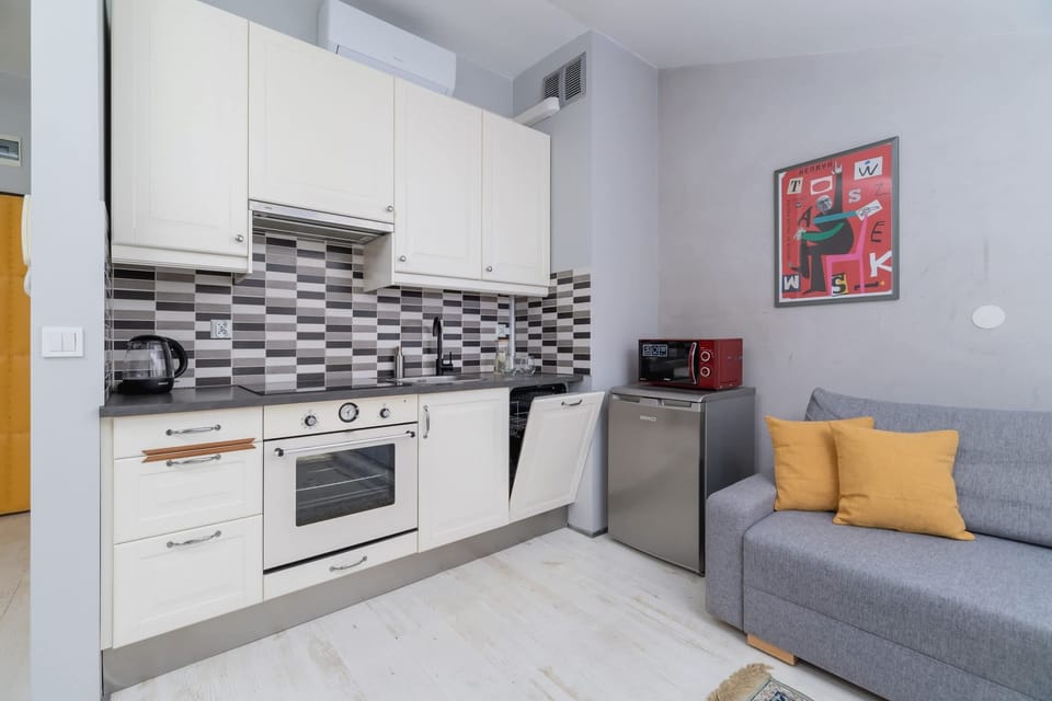 Cozy interior showcasing the practical layout of the kitchen, dining, and sitting spaces.

