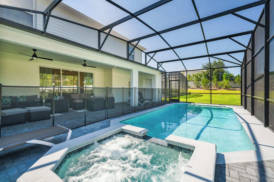 Relax in your private screened-in pool and hot tub oasis, perfect for unwinding and enjoying sunny days.
