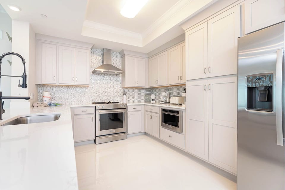 Upgrade your culinary experience in this modern kitchen with stunning appliances and elegant design