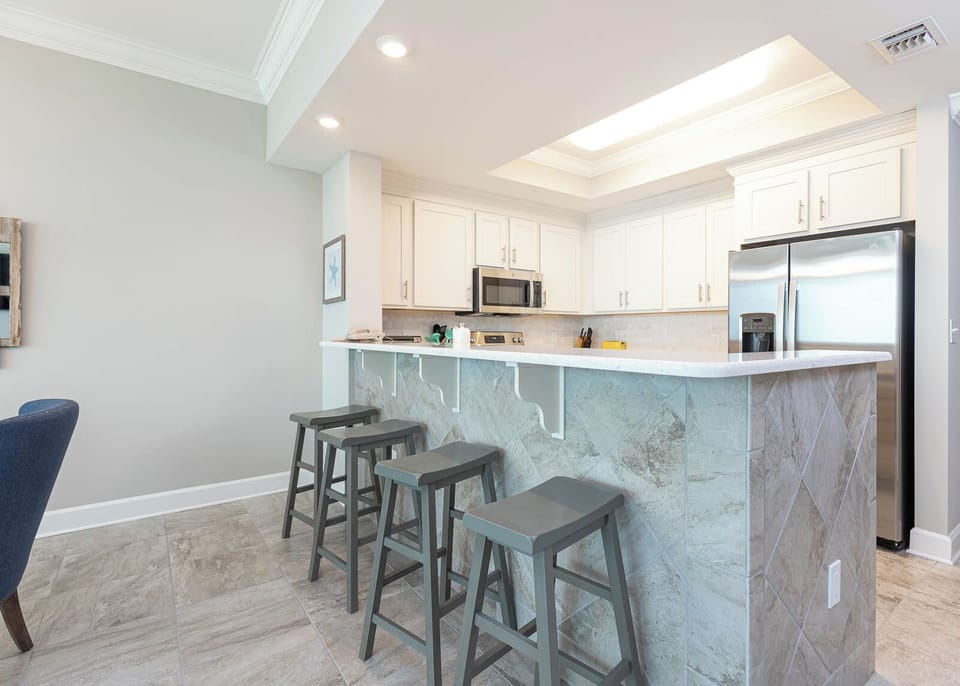 Savor your morning coffee in this inviting kitchen space with stainless appliances and stylish design