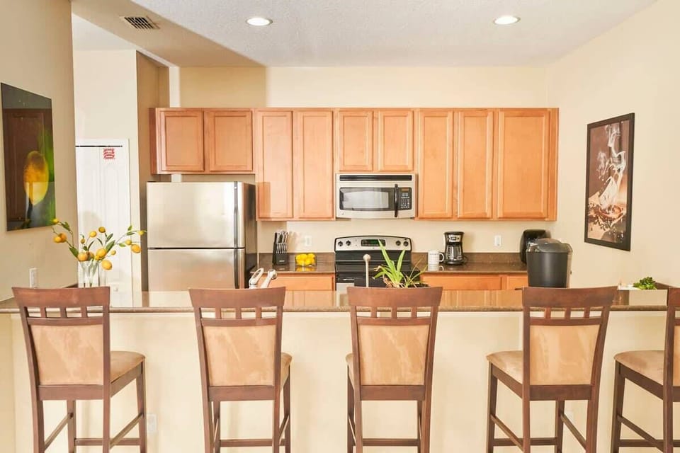 Spacious breakfast bar with seating for five.