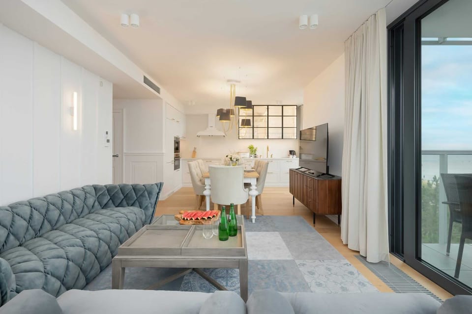 Another angle of the living and dining area, emphasizing its elegance and ocean view.

