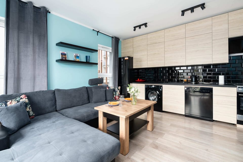 Open-plan living area with a stylish kitchen and comfortable seating for relaxation and dining.

