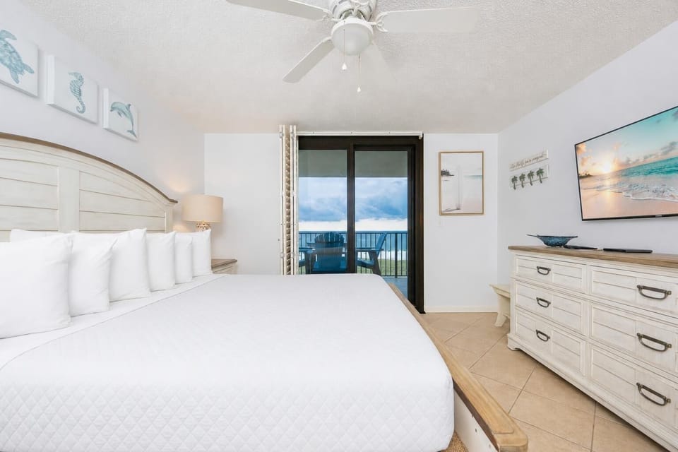Sink into the plush king bed, enjoying coastal views through sliding doors that open to your balcony