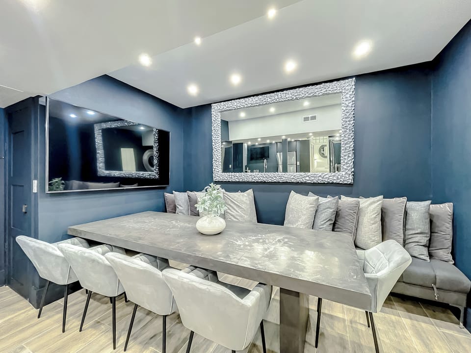 Entertain with big screens, a stone table for 12, and a fully-equipped kitchen
