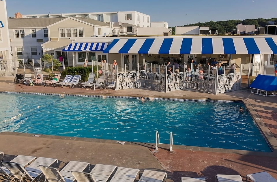 Cool off with lively pool energy beside the striped lounge.