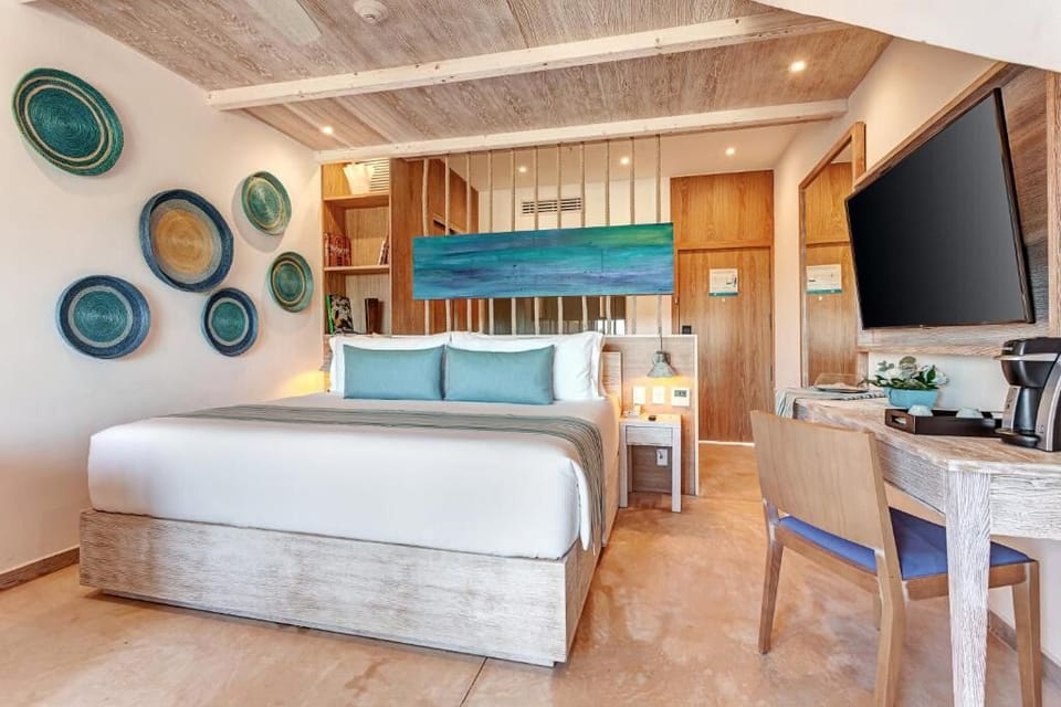 Settle into crisp linens with stylish coastal decor and TV.
