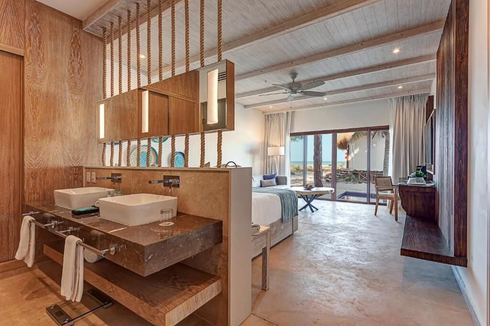 Get ready effortlessly with in-suite vanity and beach views beyond.