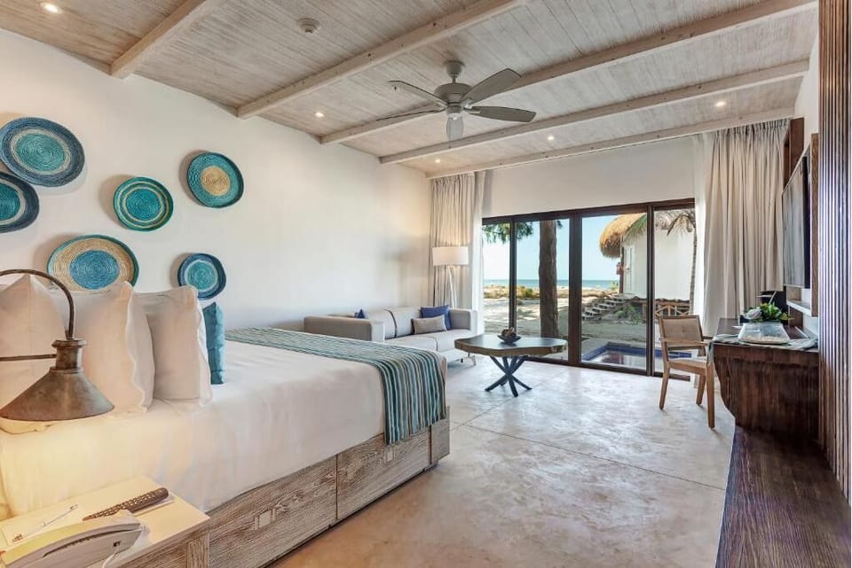 Soak up beachfront views from bed in a serene retreat.