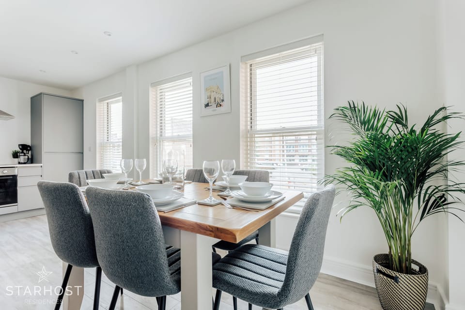 The wooden dining room table seats six guests comfortably