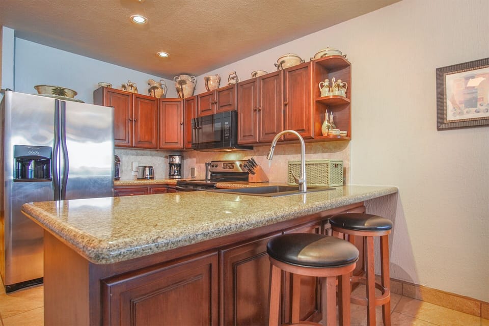 the kitchen with its counter and complete appliances
