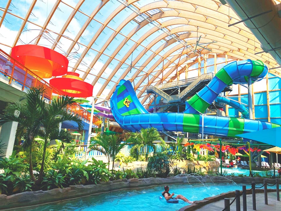 Dive into tropical fun beneath soaring indoor waterpark arches.