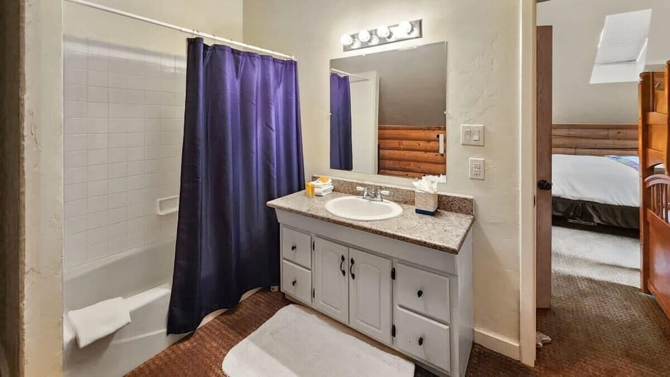 The attached full bathroom boasts a single-sink vanity with under-the-sink storage space and a shower/bathtub combo.