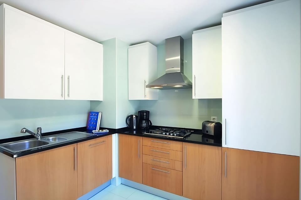 Brew coffee and prep breakfasts on generous, polished countertops.