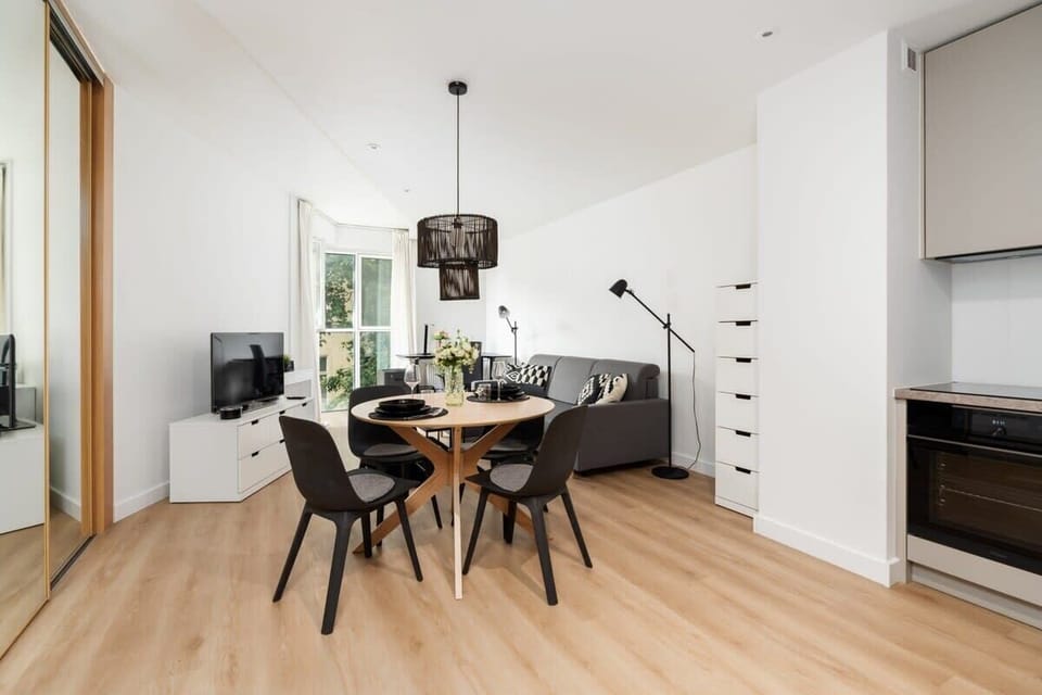Open-concept dining and kitchen area featuring sleek design and a clean aesthetic.

