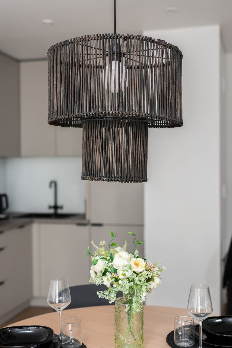 Close-up of a decorative hanging lamp over the dining area, enhancing the room's elegance.







