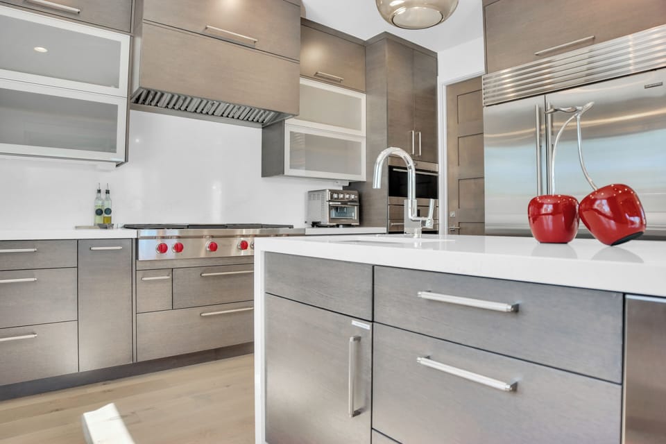 Vacation rental kitchen with stainless steel refrigerator and double ovens.
