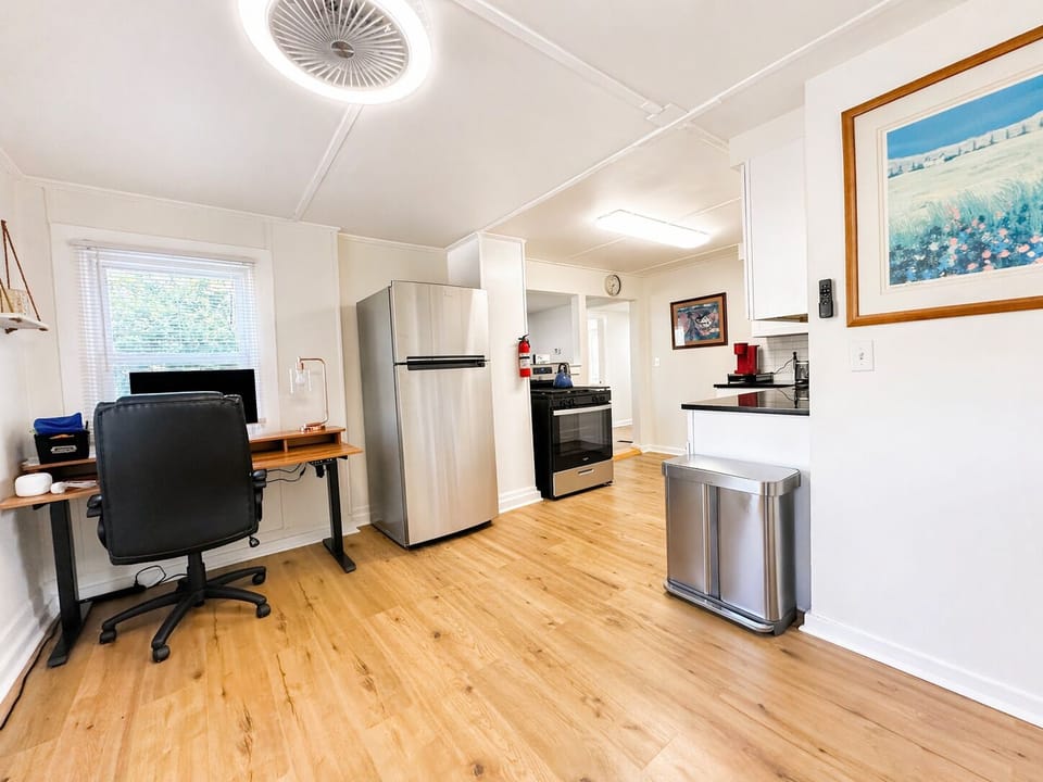 Kitchen with full fridge, gas range, workspace, and full-size microwave
