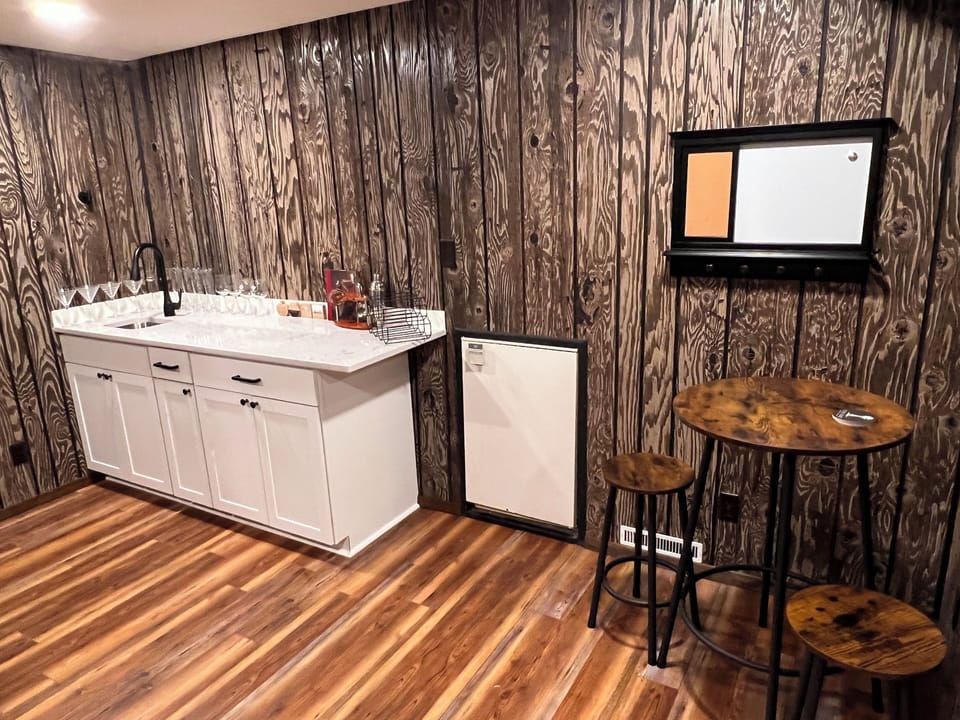 Lower level bar, sitting area. Includes office space (not pictured)