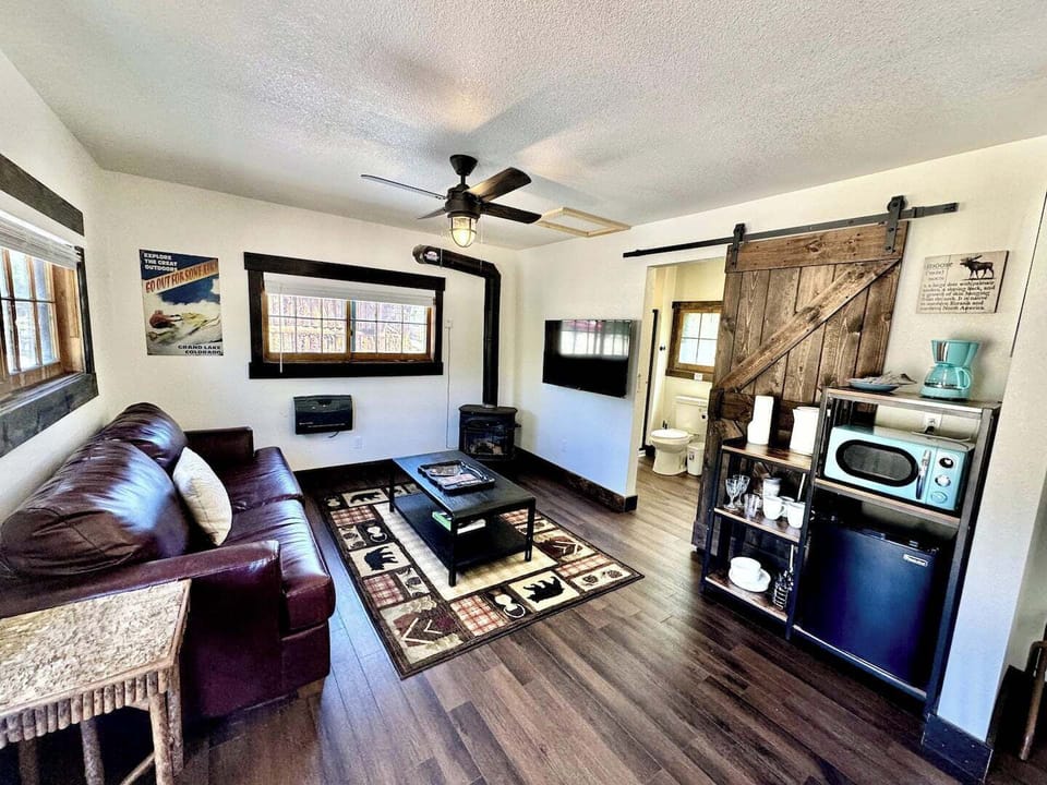 Cozy up in the lounge area, featuring warm wood tones, a crackling fireplace, and comfortable seating for ultimate relaxation.

