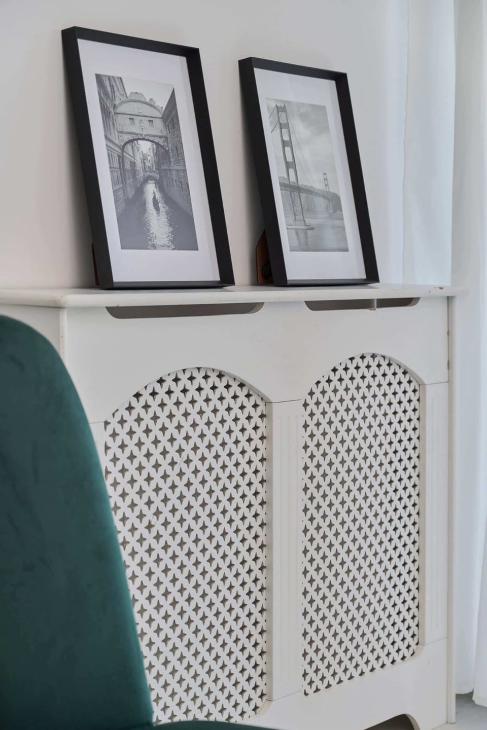 Close-up of decorative frames on a white shelf, adding an elegant touch to the interior.


