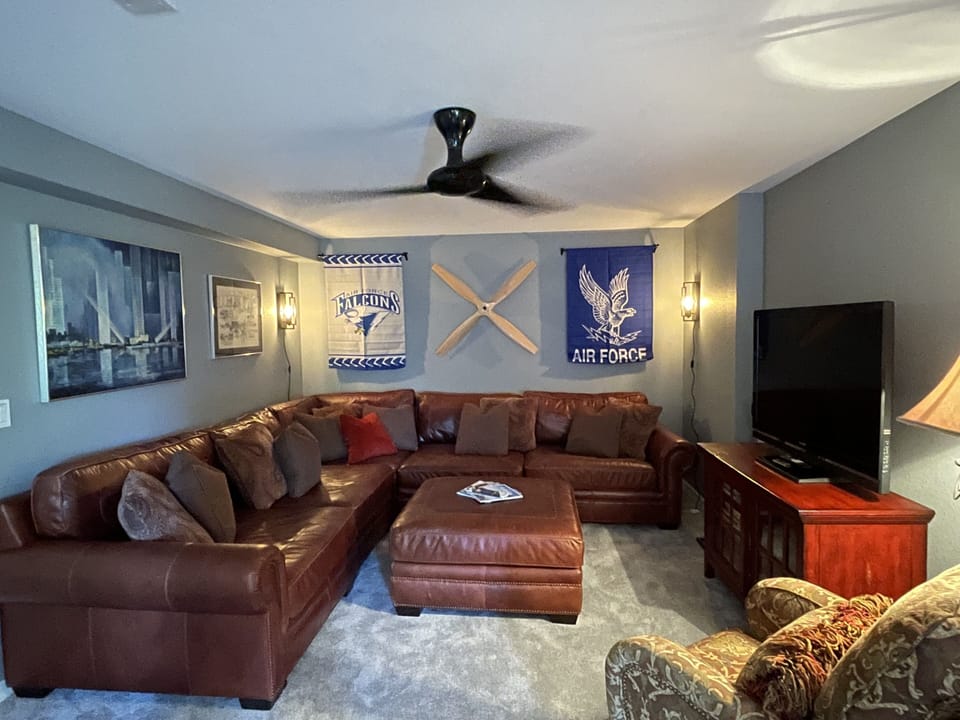 AFA themed living rm with an OVERSIZED sectional where 2 adults can easily sleep