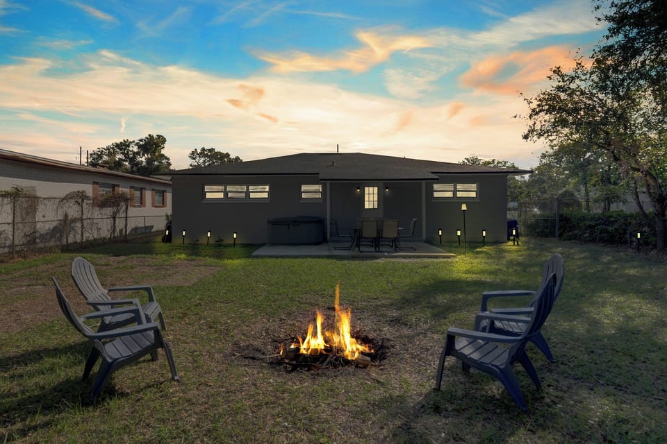 Large Backyard with Fire Pit and Outdoor Dining area with seating for six.