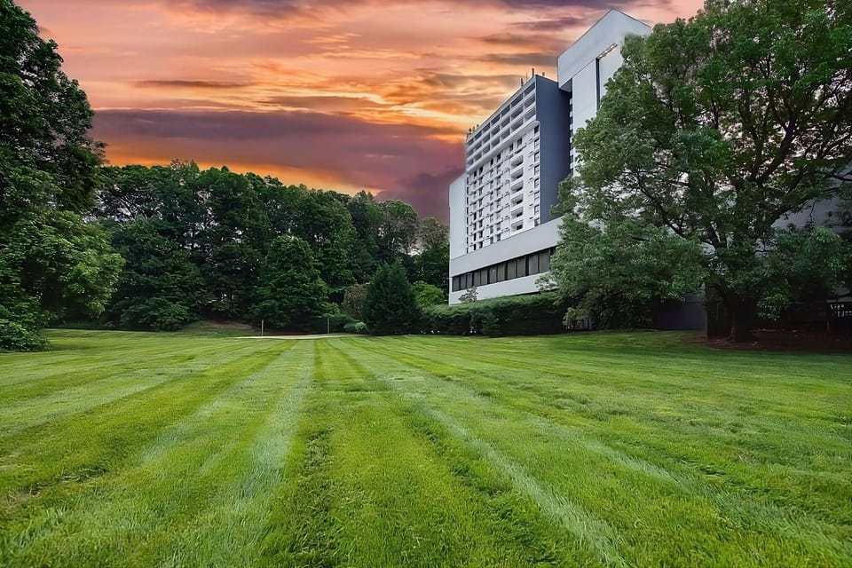 Arrive effortlessly beneath the covered porte-cochère and tall tower.