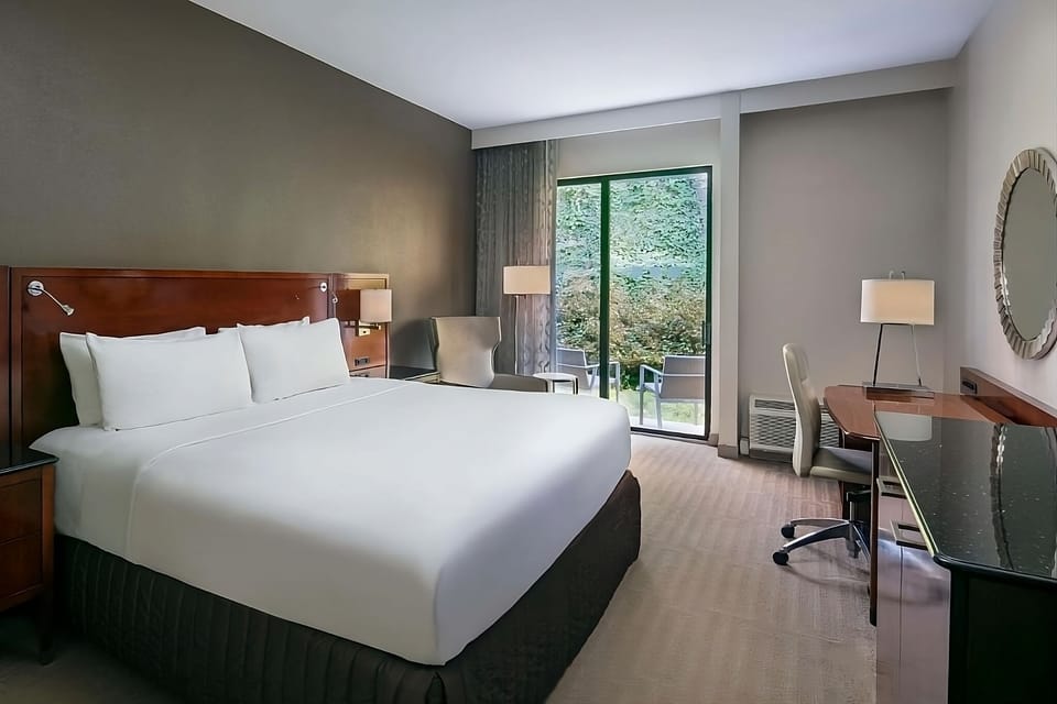 Recharge in a serene king room overlooking lush greenery.