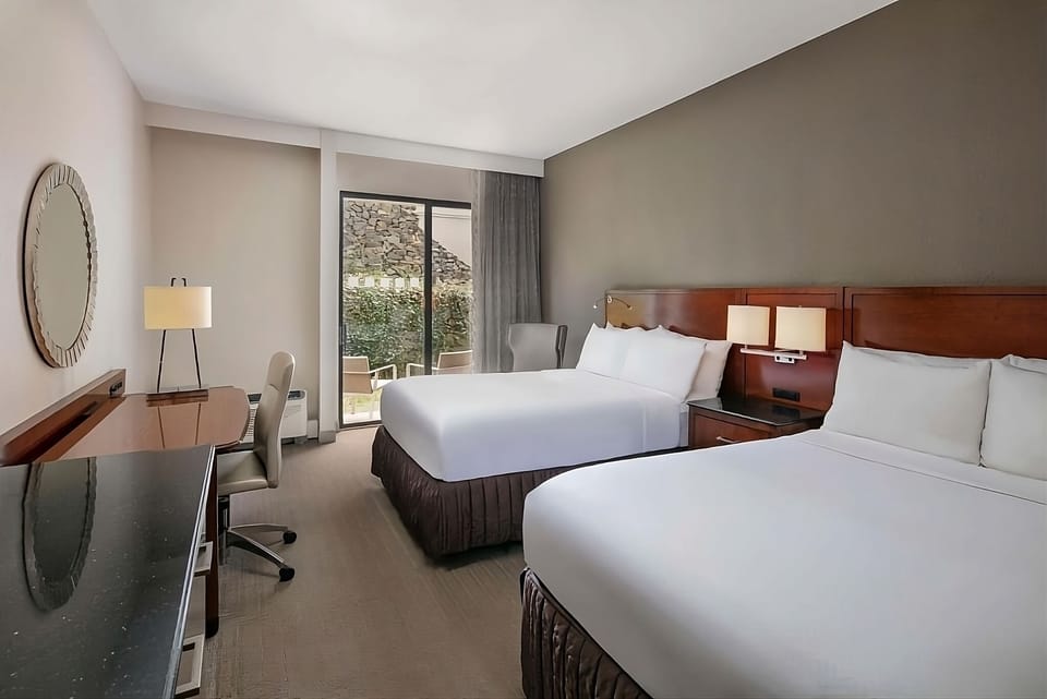 Enjoy a bright two-queen room with easy outdoor access.