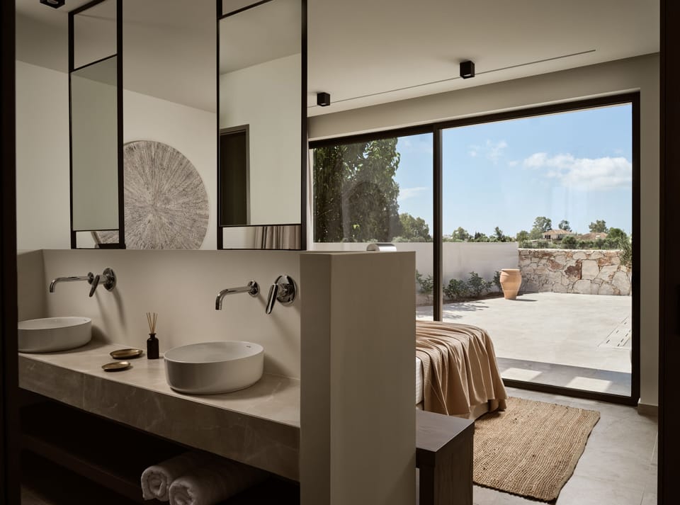 The Master bedroom features an ensuite bathroom with double sinks & pool views.