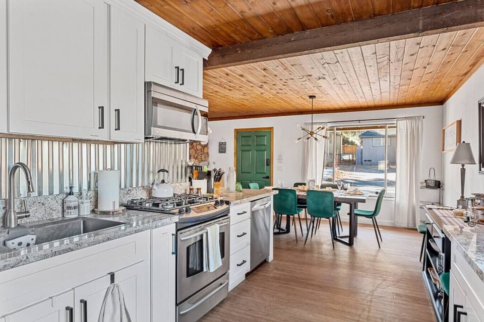 Gather around! Our cozy dining table by the kitchen is perfect for family meals and lively conversations.