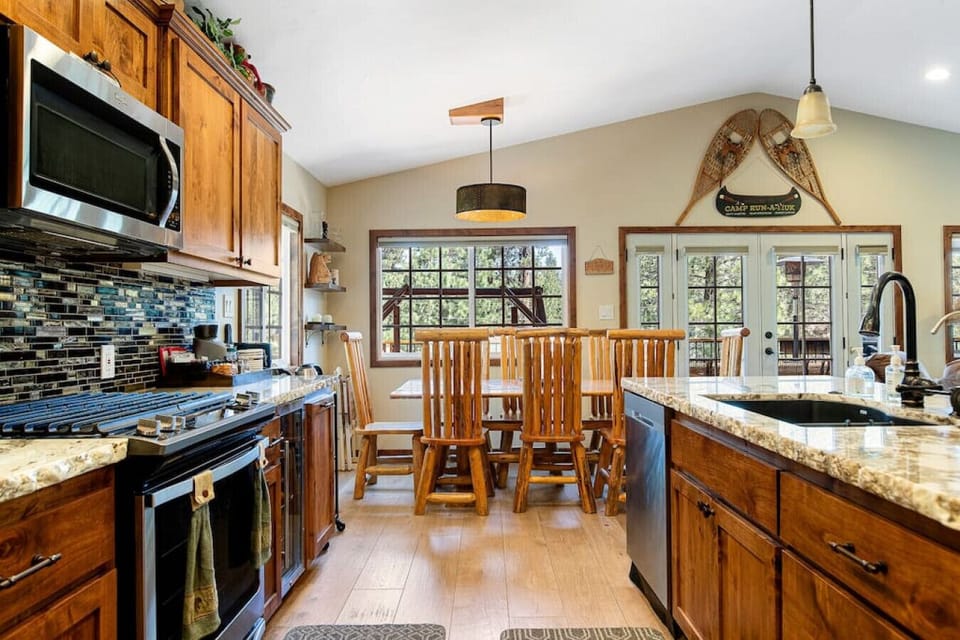 Luxe kitchen fit for a chef with granite countertops, a double basin sink, wine fridge and all stainless steel appliances.