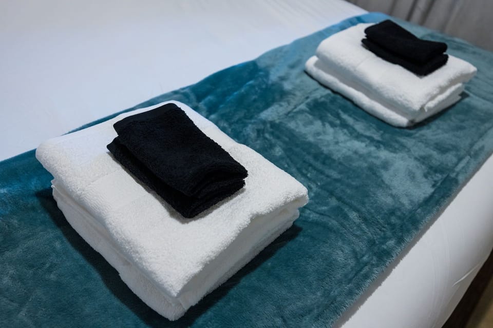 Indulge in the serene ambiance of our rental room, thoughtfully curated with three pristine towels for your convenience. Immerse yourself in comfort and relaxation during your stay.