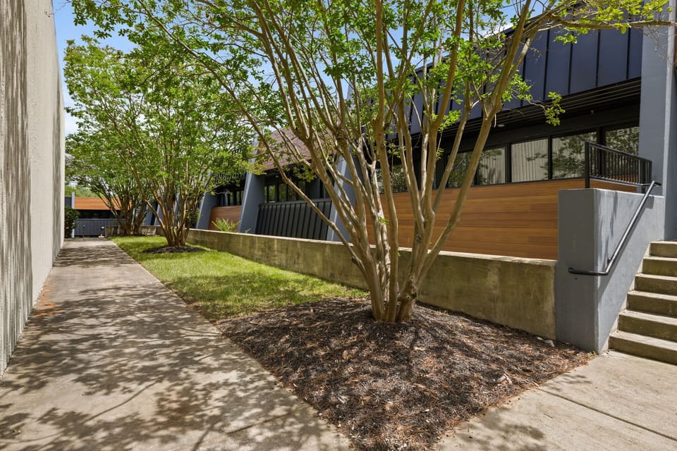 City Serenity: Uncover the ideal equilibrium of urban living and tranquility in this remarkable apartment building, embraced by a peaceful sidewalk and vibrant trees, offering a unique blend of urban energy and serene retreat.