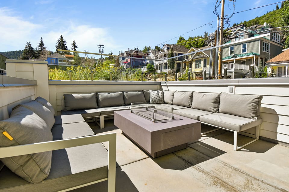 Comfortable seating surrounding your private fire pit on the balcony.