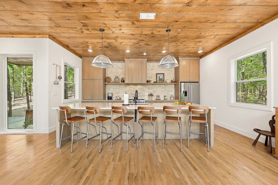 Kitchen: Sleek design and natural light unite for delightful cooking and memorable meals!