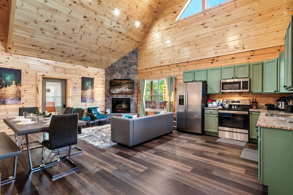 Living Space: Bright and airy retreat with modern kitchen and inviting stone fireplace!