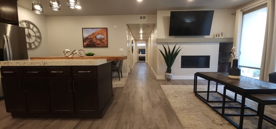 Open-concept layout with a contemporary kitchen, spacious living area, and cozy fireplace — all designed with comfort and style in mind.