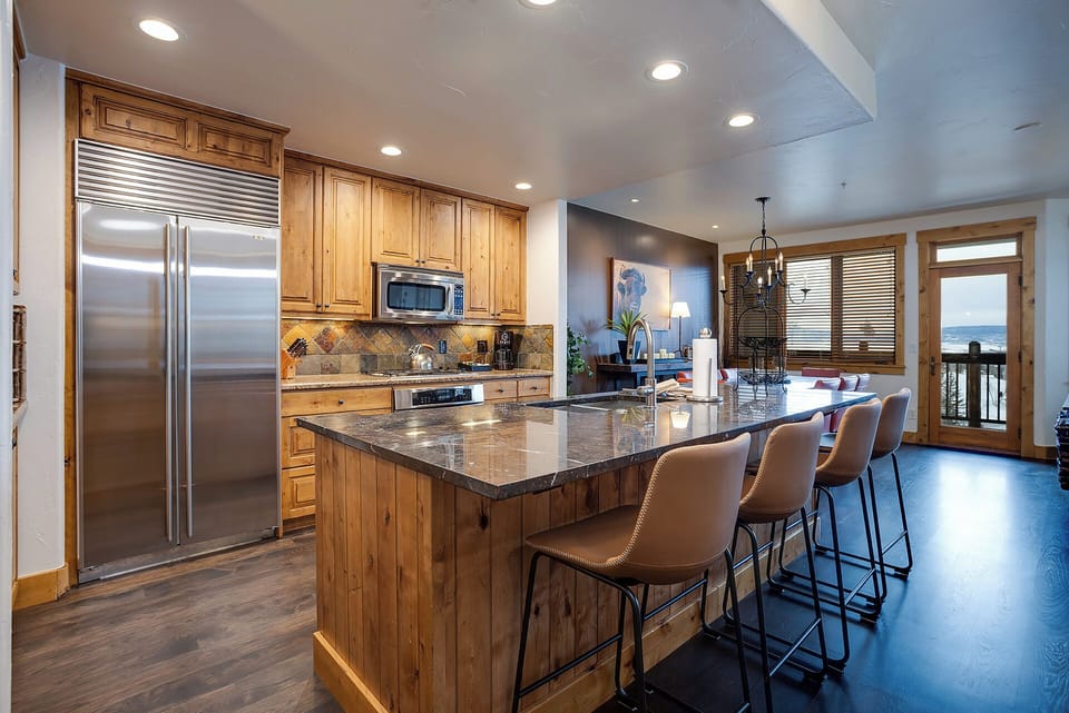 Your gourmet kitchen features granite countertops, stainless steel appliances, and breakfast bar seating where you'll enjoy morning coffee.