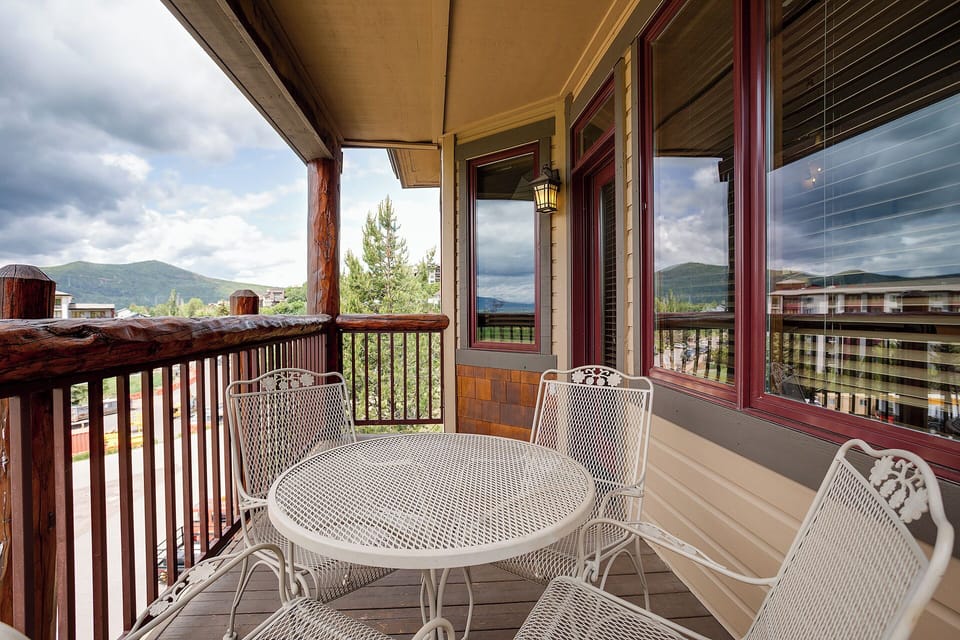 Step onto your private balcony where mountain views frame every meal at your round dining table—perfect for morning coffee or evening relaxation.