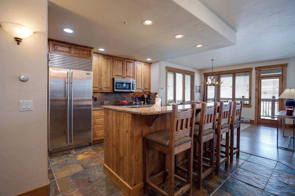Your fully-equipped kitchen features granite countertops, stainless steel appliances, and a breakfast bar where you can start each morning with coffee.