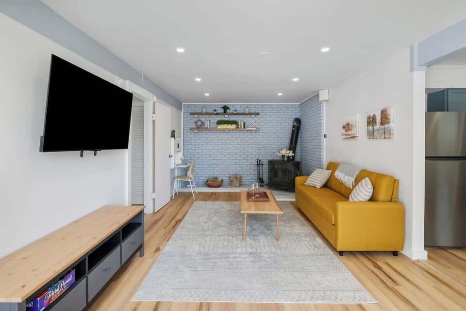 Large bright living room! TV is on a swivel to enjoy from wherever you choose!