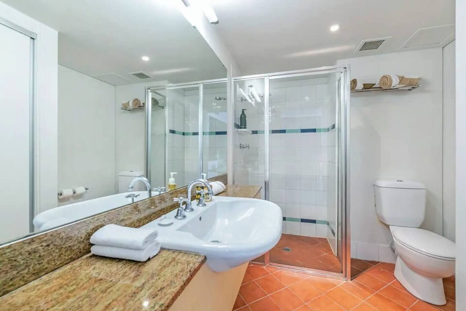 The terracotta-tiled bathroom offers complimentary towels and toiletries including shampoo, conditioner and soap.