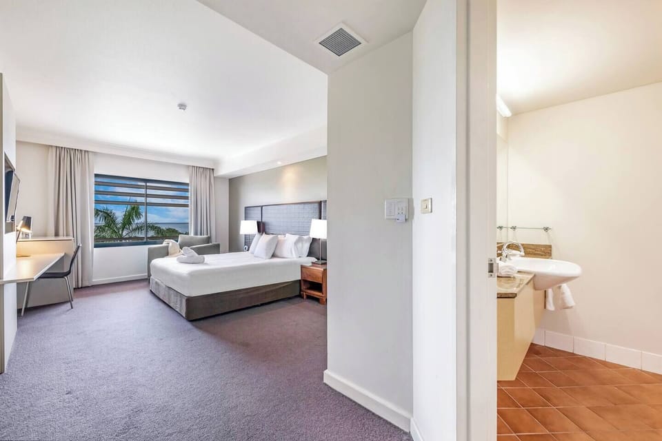 Relax by the shared tropical pool, surrounded by lush greenery and shaded sail canopies—an inviting place to cool off and unwind in Darwin’s warm climate.