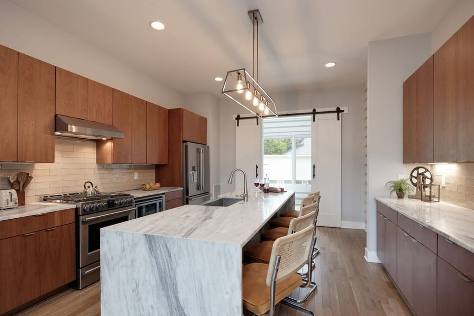 2nd Floor: Fully equipped kitchen with stainless steel appliances and stocked with all culinary essentials. Features an island with bar seating and ample counter space.