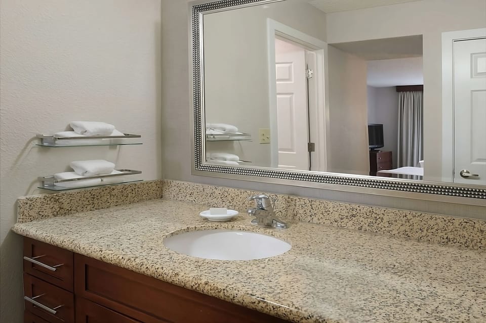 Refresh at the granite vanity with bright, easy lighting.