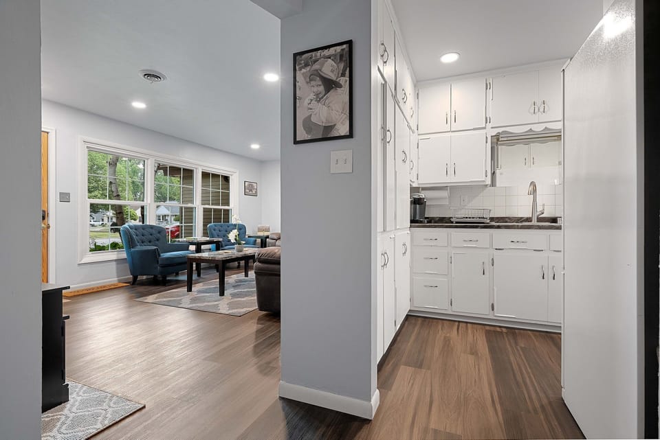 Next to the spacious living room is the crisp white and versatile kitchen with in unit laundry. microwave, fridge, freezer, Keurig, toaster oven,  and everything needed to make a home cooked meal. 