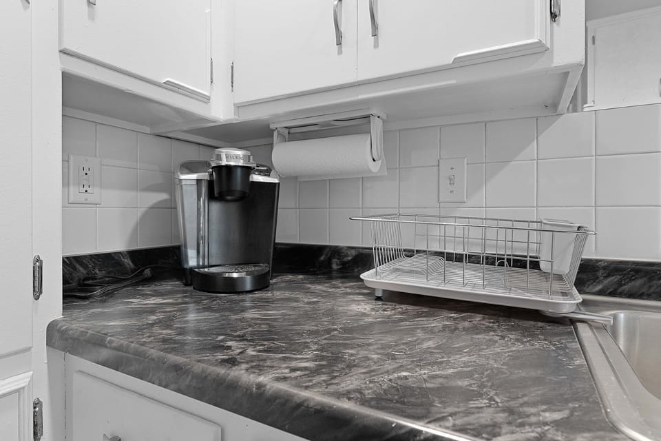 The crisp white and versatile kitchen features in unit laundry. microwave, fridge, freezer, Keurig, toaster oven,  and everything needed to make a home cooked meal. 