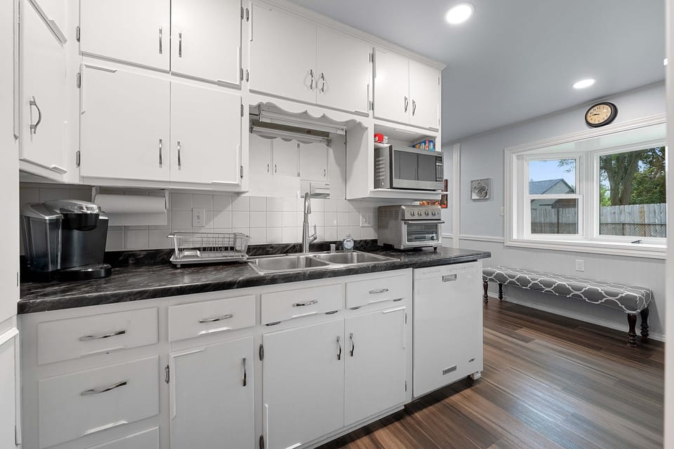 The crisp white and versatile kitchen features in unit laundry. microwave, fridge, freezer, Keurig, toaster oven,  and everything needed to make a home cooked meal. 